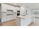 Modern kitchen with white cabinets, quartz countertops, and stainless steel appliances at 9305 Barnacle Ln, Parrish, FL 34219