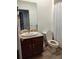 Bathroom features a vanity, a sink, a toilet, and a shower with a curtain at 3639 Hurston St, New Port Richey, FL 34655