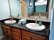Bathroom featuring a double-sink vanity with granite countertops and a separate soaking tub at 3639 Hurston St, New Port Richey, FL 34655