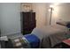 Cozy bedroom featuring a chest of drawers, a bed, an area rug and a floor lamp at 3639 Hurston St, New Port Richey, FL 34655
