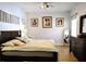 Comfortable bedroom with neutral walls, decorative paintings, and wood-look flooring at 3639 Hurston St, New Port Richey, FL 34655