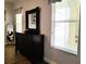 Bedroom area with a dark wood dresser and a window with white blinds at 3639 Hurston St, New Port Richey, FL 34655