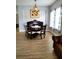 Elegant dining room with chandelier, hardwood floors, and large windows with natural light at 3639 Hurston St, New Port Richey, FL 34655