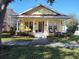 Charming yellow house with a welcoming front porch and landscaping at 3639 Hurston St, New Port Richey, FL 34655