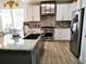 Bright kitchen with stainless steel appliances, granite countertops, and stylish copper hardware at 3639 Hurston St, New Port Richey, FL 34655