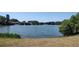 Serene lakefront view with lush greenery and tranquil atmosphere at 3639 Hurston St, New Port Richey, FL 34655