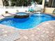 Backyard pool with brick pavers, a waterfall feature, and lounge chairs for relaxing at 3639 Hurston St, New Port Richey, FL 34655