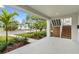 Covered front porch with wood stairs and landscaping at 1526 5Th S St, St Petersburg, FL 33701