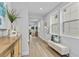 Hallway with light walls, wood floors, and a bench at 1526 5Th S St, St Petersburg, FL 33701