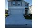 Two-story house with gray siding, shutters, and a two-car garage at 10225 Kalamazoo Pl, Parrish, FL 34219
