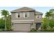 Two-story house with gray siding, two-car garage, and palm trees at 10225 Kalamazoo Pl, Parrish, FL 34219