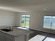 Kitchen with marble countertops, stainless steel sink, and a view of the backyard at 10225 Kalamazoo Pl, Parrish, FL 34219