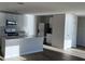 Modern kitchen with white cabinets, marble countertops, and stainless steel appliances at 10225 Kalamazoo Pl, Parrish, FL 34219