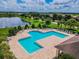 Community pool and lounge area next to lake at 20233 Still Wind Dr, Tampa, FL 33647