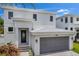 Modern two-story house featuring gray garage door and walkway at 2345 Bahia Vista St, Sarasota, FL 34239