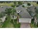 Aerial view of a house with a golf course and lake in the background at 1817 Pacific Dunes Dr, Sun City Center, FL 33573