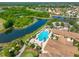 Aerial view of community featuring a pool, clubhouse, lakes, lush landscaping and golf course at 1817 Pacific Dunes Dr, Sun City Center, FL 33573