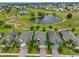 Aerial view of houses in a community near a golf course at 1817 Pacific Dunes Dr, Sun City Center, FL 33573