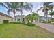 Tan house with palm trees and a brick driveway at 1817 Pacific Dunes Dr, Sun City Center, FL 33573