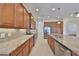 A spacious kitchen featuring stainless steel appliances, granite countertops, and beautiful wood cabinetry at 1817 Pacific Dunes Dr, Sun City Center, FL 33573