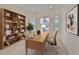 Bright office showcasing custom bookshelf, large wooden desk, and a calming view at 1817 Pacific Dunes Dr, Sun City Center, FL 33573