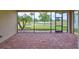 Outdoor patio with brick flooring overlooking a lush green lawn and tranquil lake at 1817 Pacific Dunes Dr, Sun City Center, FL 33573