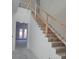 Unfinished staircase with simple wood railings leading to the upper level at 3707 W San Juan St, Tampa, FL 33629