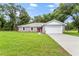 Newly built home with gray siding, stone accents, and a red front door at 11734 Orange Ct, Dade City, FL 33525