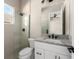 Bathroom with white vanity, granite countertop, and glass shower at 5018 Elm Leaf Dr, Brooksville, FL 34601