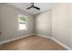 Simple bedroom with hardwood floors and a window at 5018 Elm Leaf Dr, Brooksville, FL 34601