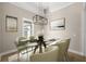 Elegant dining room with a glass table and modern chandelier at 5018 Elm Leaf Dr, Brooksville, FL 34601