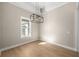 Bright dining room with hardwood floors and large window at 5018 Elm Leaf Dr, Brooksville, FL 34601