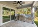 Outdoor kitchen with built-in grill, granite countertop, and stainless steel appliances at 5018 Elm Leaf Dr, Brooksville, FL 34601