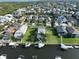 Aerial view of waterfront home with private dock and pool; surrounded by other homes at 4334 Sanddollar Ct, New Port Richey, FL 34652