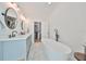 Elegant bathroom with a freestanding tub, double vanity, and walk-in closet at 4334 Sanddollar Ct, New Port Richey, FL 34652