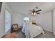 Bright bedroom with a queen-size bed, chair, and window coverings at 4334 Sanddollar Ct, New Port Richey, FL 34652