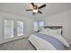 Main bedroom with ceiling fan and private balcony at 4334 Sanddollar Ct, New Port Richey, FL 34652