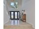 Bright entryway with tiled floors, double doors and staircase at 4334 Sanddollar Ct, New Port Richey, FL 34652