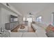 Bright living room with hardwood floors, large sectional sofa, and access to balcony at 4334 Sanddollar Ct, New Port Richey, FL 34652