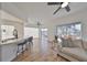 Open concept living area with hardwood floors, modern kitchen, and balcony access at 4334 Sanddollar Ct, New Port Richey, FL 34652
