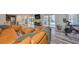 Open concept living space with leather sectional and access to patio at 4334 Sanddollar Ct, New Port Richey, FL 34652
