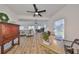 Spacious living room with light hardwood floors, sectional sofa, and large windows with access to a patio at 4334 Sanddollar Ct, New Port Richey, FL 34652