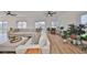 Bright living room with sectional sofa, hardwood floors, ceiling fans and access to a deck at 4334 Sanddollar Ct, New Port Richey, FL 34652