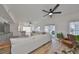 Open-concept living room with sectional sofa, hardwood floors, and access to a kitchen and patio at 4334 Sanddollar Ct, New Port Richey, FL 34652