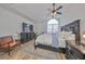 Main bedroom with king-size bed, large TV and an arched window at 4334 Sanddollar Ct, New Port Richey, FL 34652