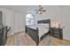 Main bedroom featuring king bed, ceiling fan and ensuite bathroom access at 4334 Sanddollar Ct, New Port Richey, FL 34652