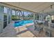 Relaxing pool area with patio furniture and string lights at 4334 Sanddollar Ct, New Port Richey, FL 34652
