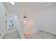 Bright upstairs hallway with carpet and access to bedrooms at 4334 Sanddollar Ct, New Port Richey, FL 34652