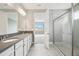 Double vanity bathroom with grey tile and shower at 2416 Clary Sage Dr, Spring Hill, FL 34609