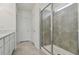 Bathroom with walk-in shower and grey tile at 12733 Wanderlust Pl, Parrish, FL 34219